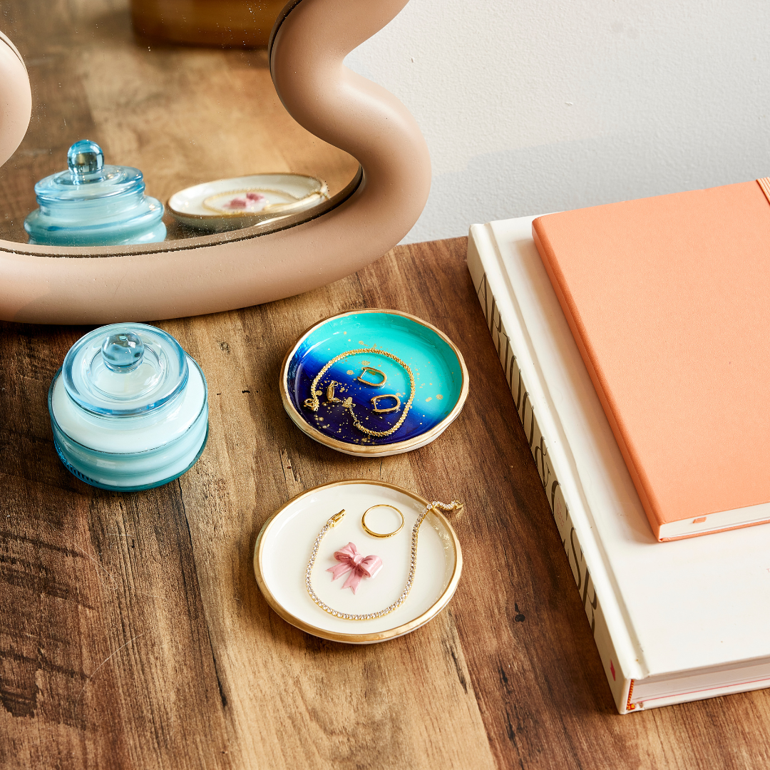 Decorative small dishes with blue and gold designs on a wooden surface.