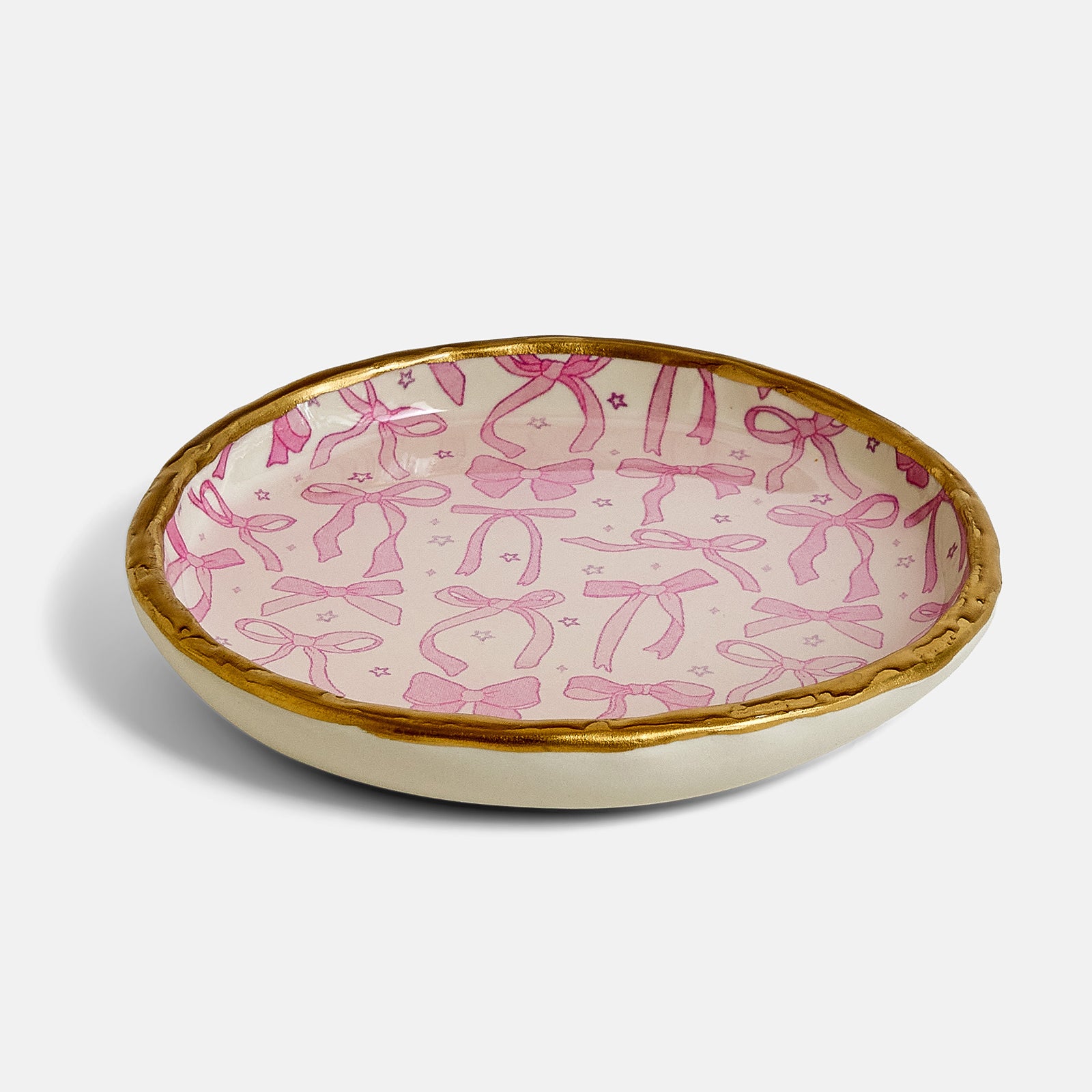 Decorative bowl with pink bow pattern on a cream background
