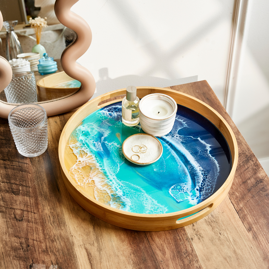 Round wooden tray with a blue and white design on a wooden surface