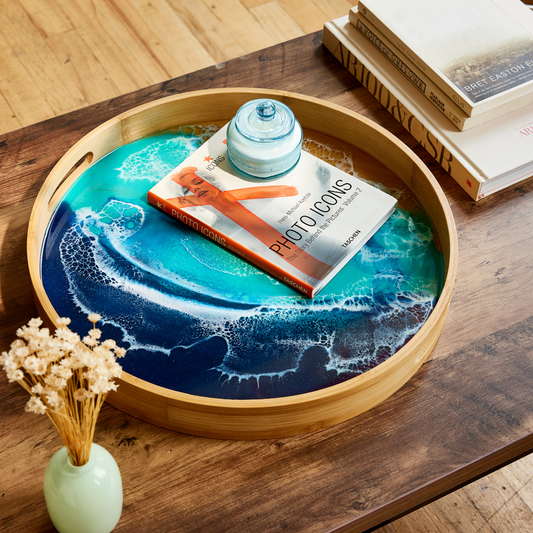 Round wooden tray with a blue ocean design on a wooden surface