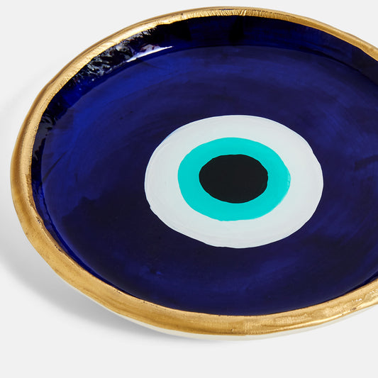 Decorative plate with the evil eye design on a blue background