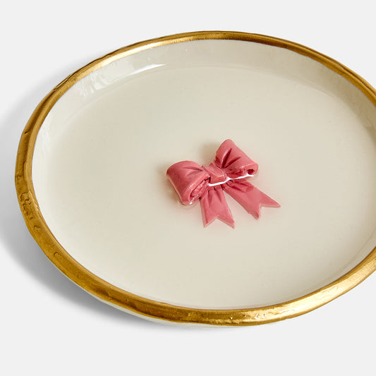 Pink bow Ring Dish on a white with gold rim